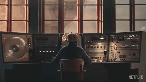 Man Sitting At Desk With Netflix Logo GIF
