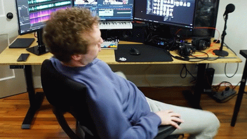 Man At Desk With Monitors And Keyboard GIF