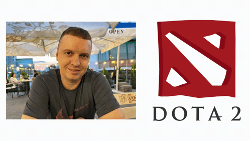 A Man Sits At A Table Next To A Logo For The Video Game Dota 2 GIF