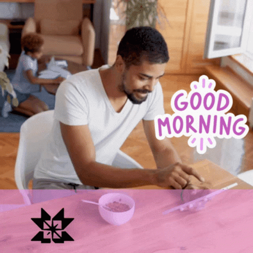 A Man Sits At A Table With A Bowl Of Cereal And A Good Morning Sticker On The Bottom GIF