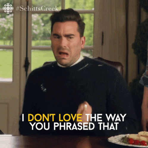 A Man Sits At A Table With A Plate Of Food And Says " I Don T Love The Way You Phrased That " GIF