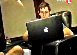 A Man Sits In A Chair With An Apple Laptop GIF