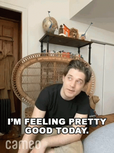 A Man Sits In A Wicker Chair With The Words " I 'M Feeling Pretty Good Today " Above Him GIF