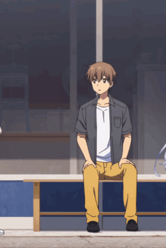 A Man Sits On A Bench With His Legs Crossed GIF