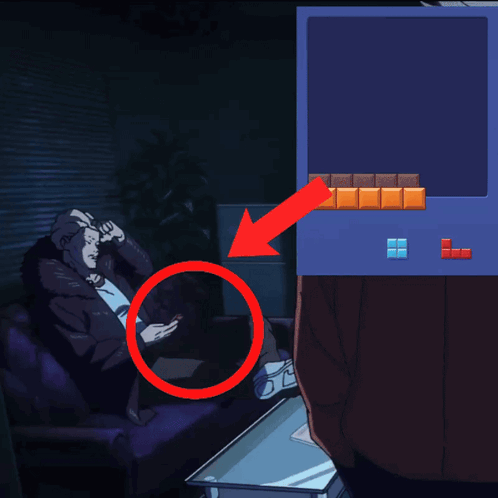 A Man Sits On A Couch Looking At His Phone Next To A Tetris Screen GIF
