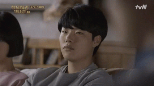 A Man Sits On A Couch With A Tvn Logo In The Corner GIF