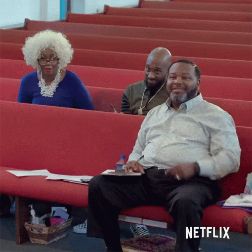 Man Sitting On Church Bench With Netflix Logo GIF