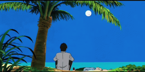 A Man Sits Under A Palm Tree While A Woman Lies On The Beach GIF