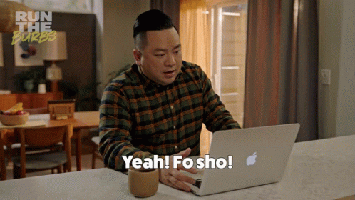A Man Sitting At A Counter Using An Apple Laptop And Says Yeah Fo Sho GIF