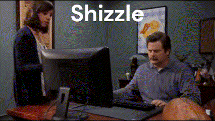 A Man Sitting At A Desk With A Computer And The Word Shizzle Behind Him GIF