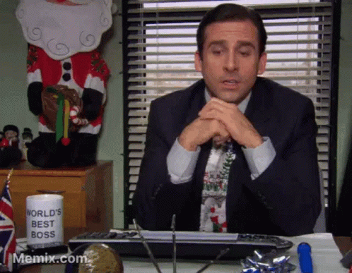 A Man Sitting At A Desk With A World 'S Best Boss Mug On It GIF