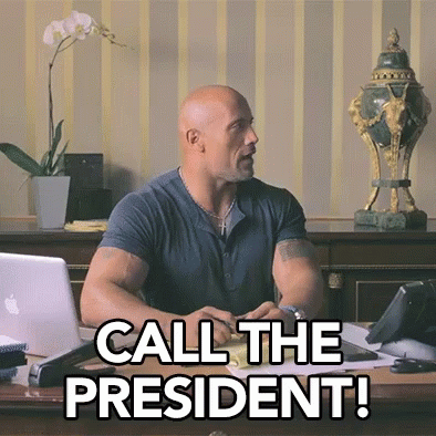 A Man Sitting At A Desk With The Words Call The President Written On It GIF