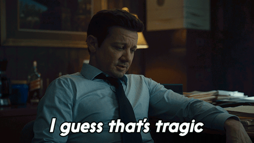 A Man Sitting At A Desk With The Words " I Guess That 'S Tragic " Above Him GIF