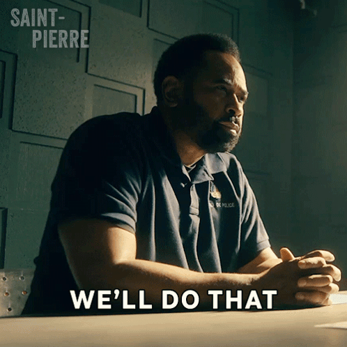 A Man Sitting At A Desk With The Words We 'Ll Do That Written On The Bottom GIF