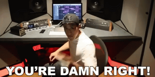 A Man Sitting At A Desk With The Words " You 'Re Damn Right " Written Below Him GIF