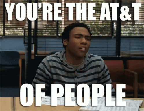 A Man Sitting At A Desk With The Words " You 'Re The At & T Of People " On The Bottom GIF