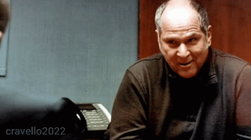 A Man Sitting At A Desk With The Year 2022 Written On The Bottom GIF