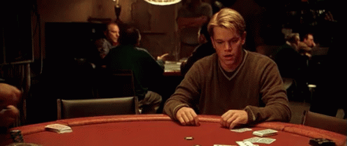 A Man Sitting At A Poker Table With Cards And Chips GIF
