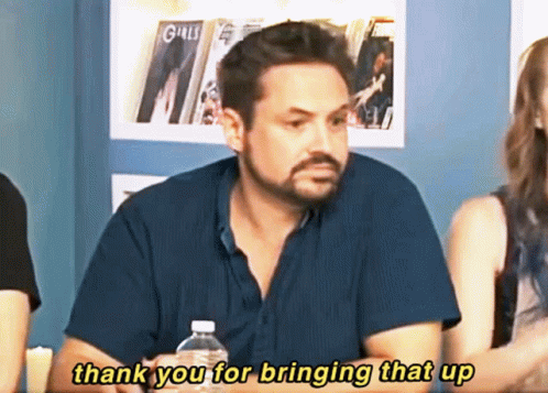 A Man Sitting At A Table With A Bottle Of Water Says Thank You For Bringing That Up GIF