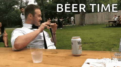 A Man Sitting At A Table With A Can Of Miller Lite Beer GIF