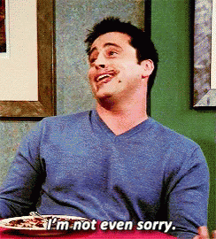 A Man Sitting At A Table With A Plate Of Food And Says I 'M Not Even Sorry GIF