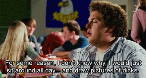 A Man Sitting At A Table With A Sign That Says Xtreme GIF