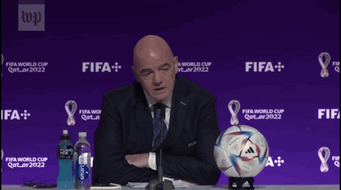 A Man Sitting At A Table With A Soccer Ball That Says Today I Feel On It GIF