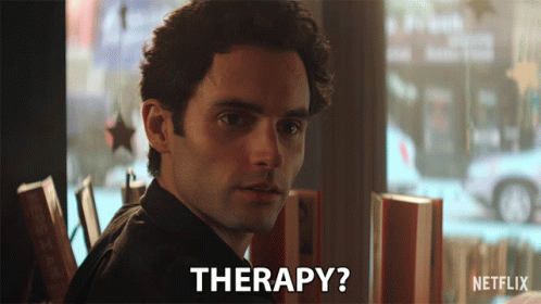 A Man Sitting At A Table With The Word Therapy Written On The Bottom GIF