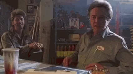 A Man Sitting At A Table With The Words I 'M On It Written On His Face GIF