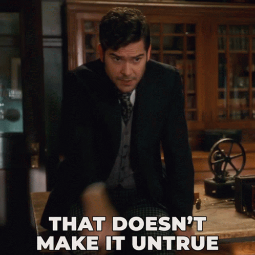 A Man Sitting At A Table With The Words That Does N't Make It Untrue Written Below Him GIF