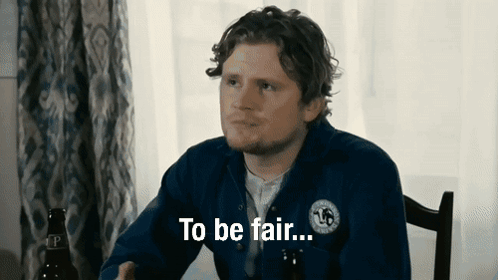 A Man Sitting At A Table With The Words To Be Fair Written On His Shirt GIF