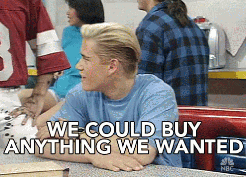 A Man Sitting At A Table With The Words " We Could Buy Anything We Wanted " On The Bottom GIF