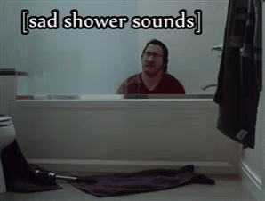 A Man Sitting In A Bathtub With The Words Sad Shower Sounds Above Him GIF