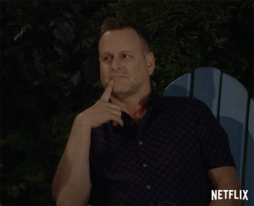 A Man Sitting In A Blue Chair With A Netflix Logo On The Bottom Right GIF