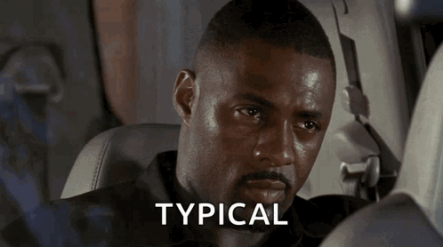 A Man Sitting In A Car With The Word Typical Written On The Screen GIF