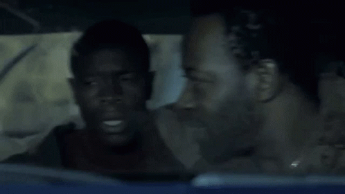 A Man Sitting In A Car With The Words Course I Am Above His Head GIF