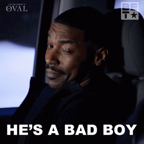 A Man Sitting In A Car With The Words He 'S A Bad Boy Below Him GIF