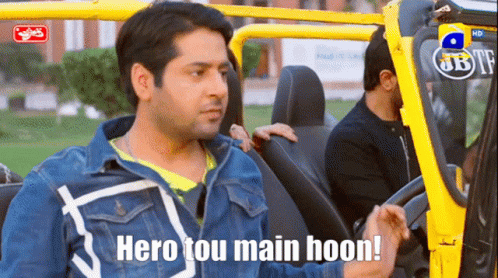 A Man Sitting In A Car With The Words Hero Tou Main Hoon Above Him GIF