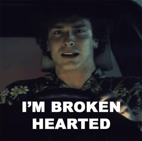 A Man Sitting In A Car With The Words I 'M Broken Hearted Behind Him GIF