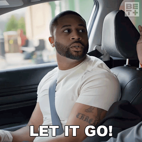 A Man Sitting In A Car With The Words Let It Go On The Bottom GIF