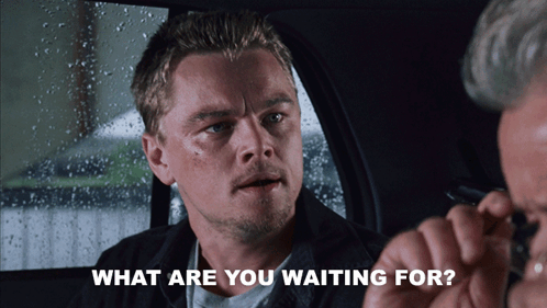A Man Sitting In A Car With The Words " What Are You Waiting For " Next To Him GIF