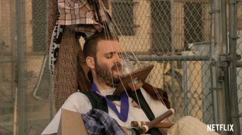 Man Sitting In Cardboard Box With Netflix Logo GIF