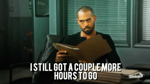 A Man Sitting In A Chair Holding A Clipboard With The Words " I Still Got A Couple More Hours To Go " GIF