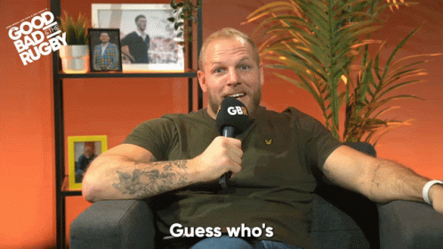 A Man Sitting In A Chair Holding A Microphone That Says Gb GIF