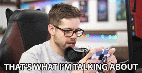 A Man Sitting In A Chair Holding A Video Game Controller With The Words That 'S What I 'M Talking About Below Him GIF