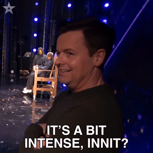 A Man Sitting In A Chair On A Stage Says It 'S A Bit Intense Innit GIF