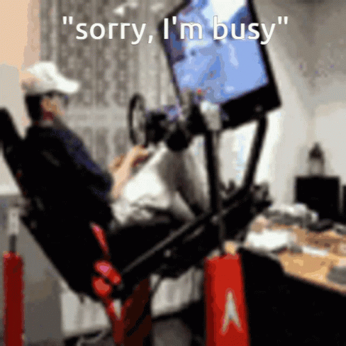 A Man Sitting In A Chair Playing A Video Game With The Words " Sorry I 'M Busy " GIF