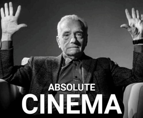 A Man Sitting In A Chair With His Hands In The Air And The Words Absolute Cinema Above Him GIF