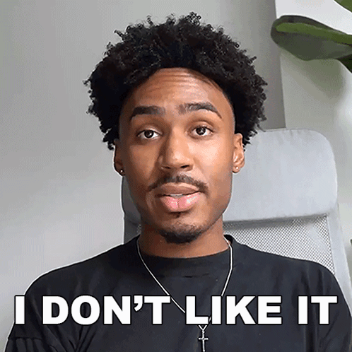 A Man Sitting In A Chair With His Tongue Sticking Out And The Words " I Don 'T Like It " Written On His Face GIF