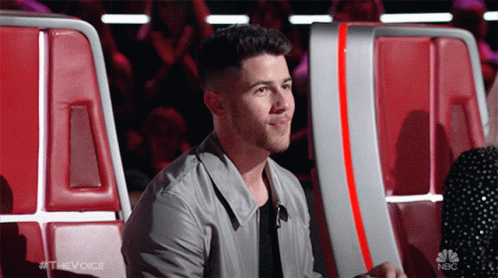 A Man Sitting In A Chair With The Word The Voice On The Bottom GIF